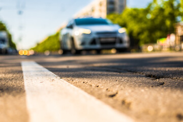 Sunny day in a city, view of the approaching car to the road level