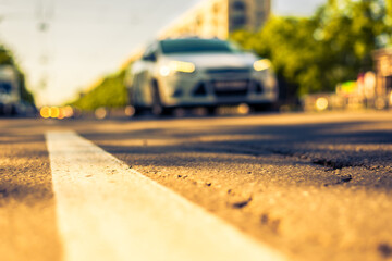 Sunny day in a city, view of the approaching car to the road level