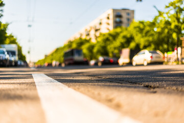 Sunny day in a city, view of the flow of cars to the road level