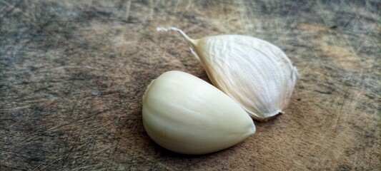 the garlic lies on a wooden table. Garlic on vintage wood background.