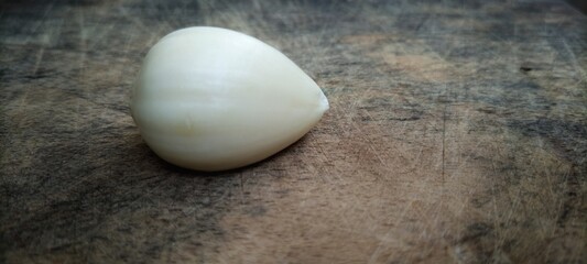 the garlic lies on a wooden table. Garlic on vintage wood background.