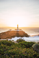 lighthouse with shadow at sunrise