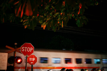 stop sign on the street. railroad crossings at night in java Indonesia