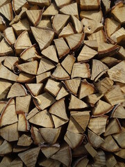 a lot of brown firewood lies on top of each other, background texture