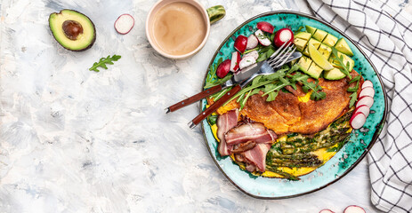 Breakfast. Omelette with asparagus, fried egg, avocado, arugula, bacon ham and cheese. Keto breakfast for keto diet. place for text, top view