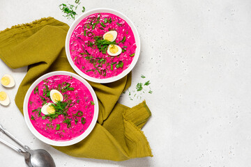 Chłodnik (Šaltibarščiai) - traditional east european soup. Cold summer soup of beets, kefir, cucumbers, eggs and dill in a white bowl top view. Summer food, Eastern European cuisine. - obrazy, fototapety, plakaty