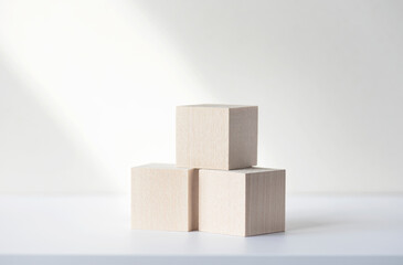 Three wooden square blocks or cubes on white desk. Mockup, space for text. Concept business picture.