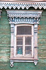 Old Russian wooden window in a house in an urban area.