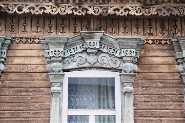 Fragment An old Russian window with carved decorations from the times of the Russian Empire in the central part of the old Russian city of Penza. Every year, the old architecture in the city becomes l