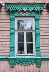 Old Russian wooden window in a house in an urban area.