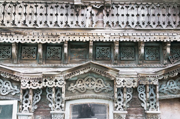Fragment An old Russian window with carved decorations from the times of the Russian Empire in the central part of the old Russian city of Penza. Every year, the old architecture in the city becomes l