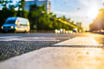 Sunny day in a city, view of the passing cars with level pedestrian crossing