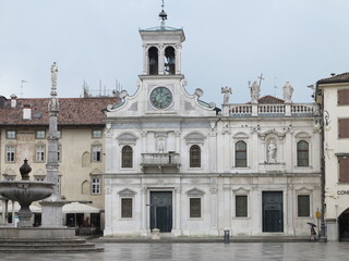 Fototapeta na wymiar White Old San Giacomo Church Facade and Buildings in Udine, Friuli Venezia Giulia, Italy