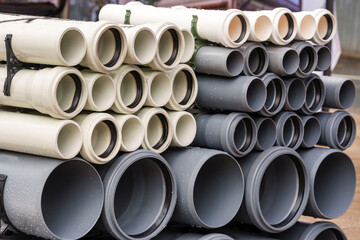 Plastic main pipes. A heap of polyethylene pipes for a water supply system. Objects for laying of...