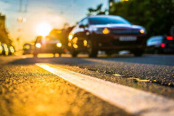 Sunny day in a city, view of the approaching cars to the road level