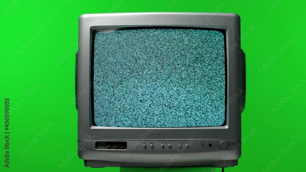 Poster old tv set in the studio on a green screen of chroma key. white noise effect on the screen. analog s