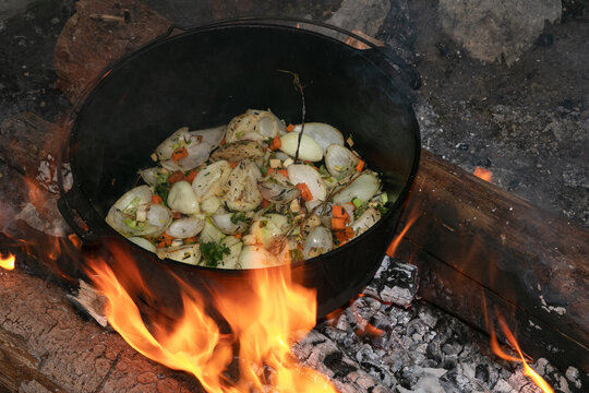 Outdoor cooking in the dutch oven,  stir-fried vegetables, campfire recipes