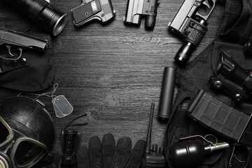 Airsoft equipment on the black flat lay background with copy space.