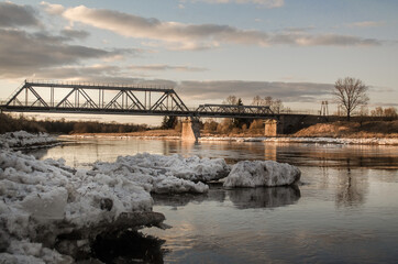 Fototapeta premium River Venta, pieces of ice and railway bridge in Skrunda, Latvia.