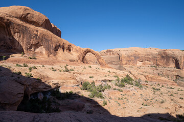 Shadows begin to fall on the scenery near Corona Arch near Moab Utah