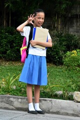 Intimidating Youthful Filipina Person With Textbooks Standing