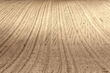 Landscape agricultural land in slope recently plowed for the crop