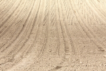 Landscape agricultural land in slope recently plowed for the crop