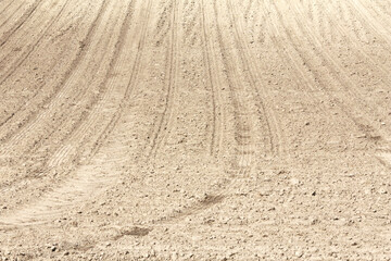 Naklejka premium Landscape agricultural land in slope recently plowed for the crop