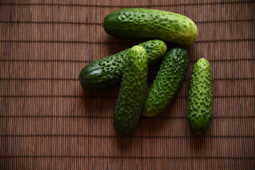 Fresh cucumbers against the background of brown bamboo napkin