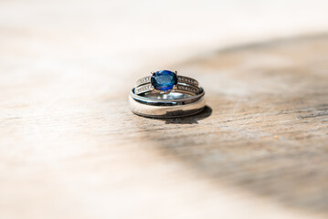 Blue sapphire engagement ring with wedding band. Macro view with bokeh