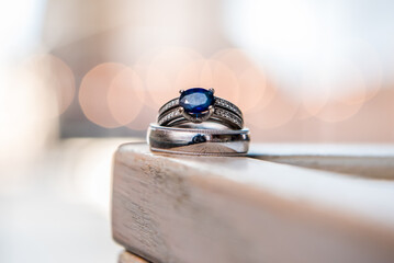 Blue sapphire engagement ring with wedding band. Macro view with bokeh