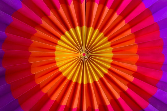 High angle horizontal closeup view of rainbow coloured paper fan