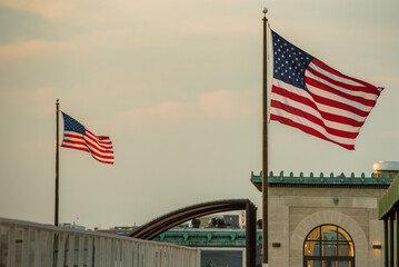 US flags waving above DC skyline.