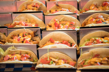 Corn tortilla fish tacos with cubed tomatoes and lettuce. Flat lay composition
