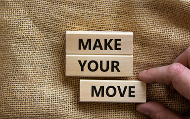 Make your move symbol. Wooden blocks with words 'Make your move'. Beautiful canvas background, businessman hand. Business, make your move concept, copy space.