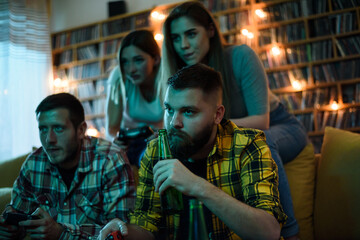 A group of friends playing video games while relaxing at home