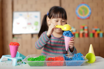 young girl pretend playing selling ice cream at home
