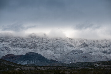 Low lying clouds and snow cover the Franklin Mountains in El Paso Texas. 