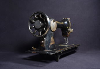 Old sewing machine on a dark background