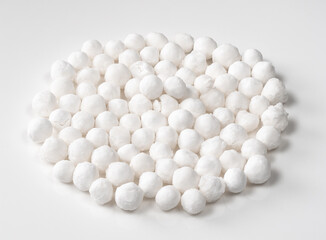 Fototapeta na wymiar pile of raw tapioca pearls closeup on white