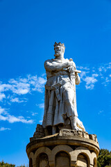 Fototapeta na wymiar big king statue in a park in Zaragoza, Spain on a warm spring day