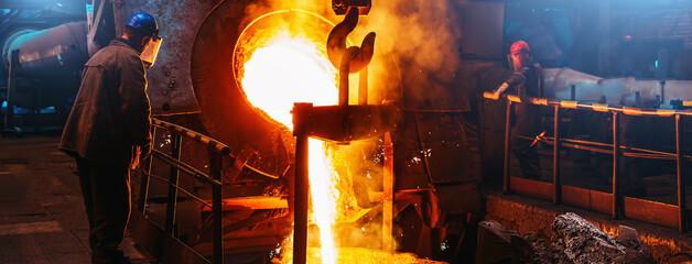 Cast iron, blast furnace in foundry, liquid molten metal pouring in ladle, metallurgical factory,...