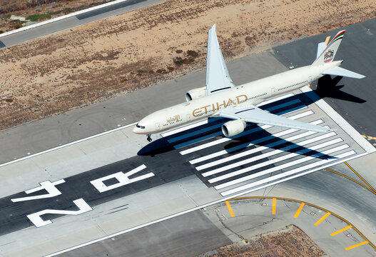 Etihad Airways A6-ETM Boeing 777 wearing old livery landing at Los Angeles International Airport. Aerial view of 777-300 aircraft registered as A6-ETM