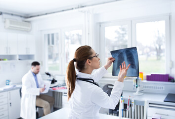 Doctors lab technicians working in laboratory reading x-ray