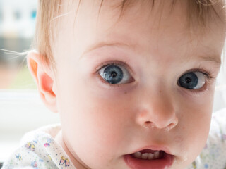 Close-up of a beautiful blue-eyed child's face