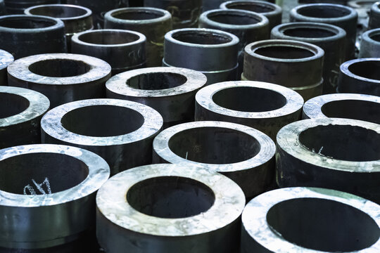 Finished metal cylindrical tubular pipe products in metal processing plant.