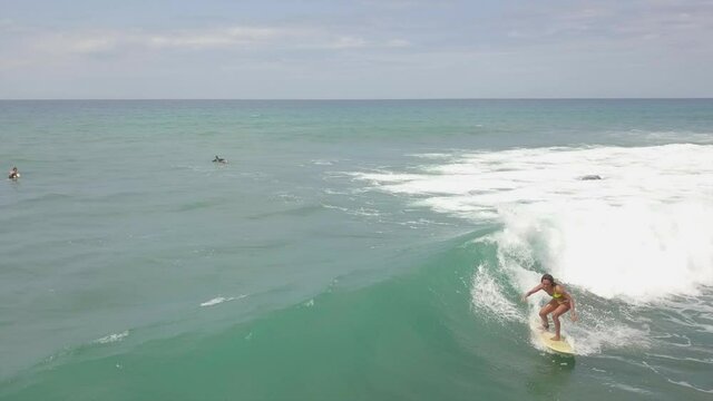 Aerial Shot Of People Surfing In Ocean On Sunny Day, Drone Flying Over Waves Against Sky - Zambales, Philippines 