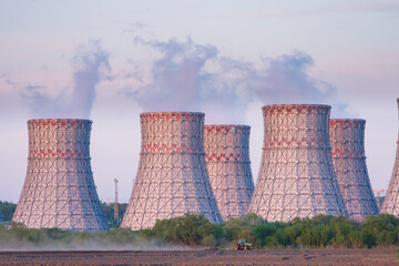 Cooling towers of Nuclear power plant emissions of steam in the air atmosphere. Industrial zone...