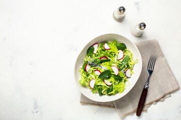 Vegetarian fresh green salad. Healthy food, diet lunch. Top view on a white background.
