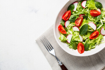 Bowl with vegetarian fresh salad. Healthy food, diet lunch. Top view on a white background.
